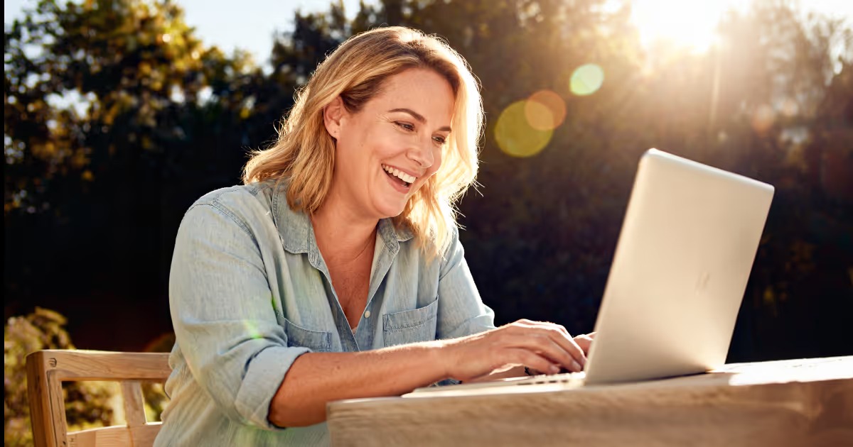 Woman completing an online health consultation on a laptop