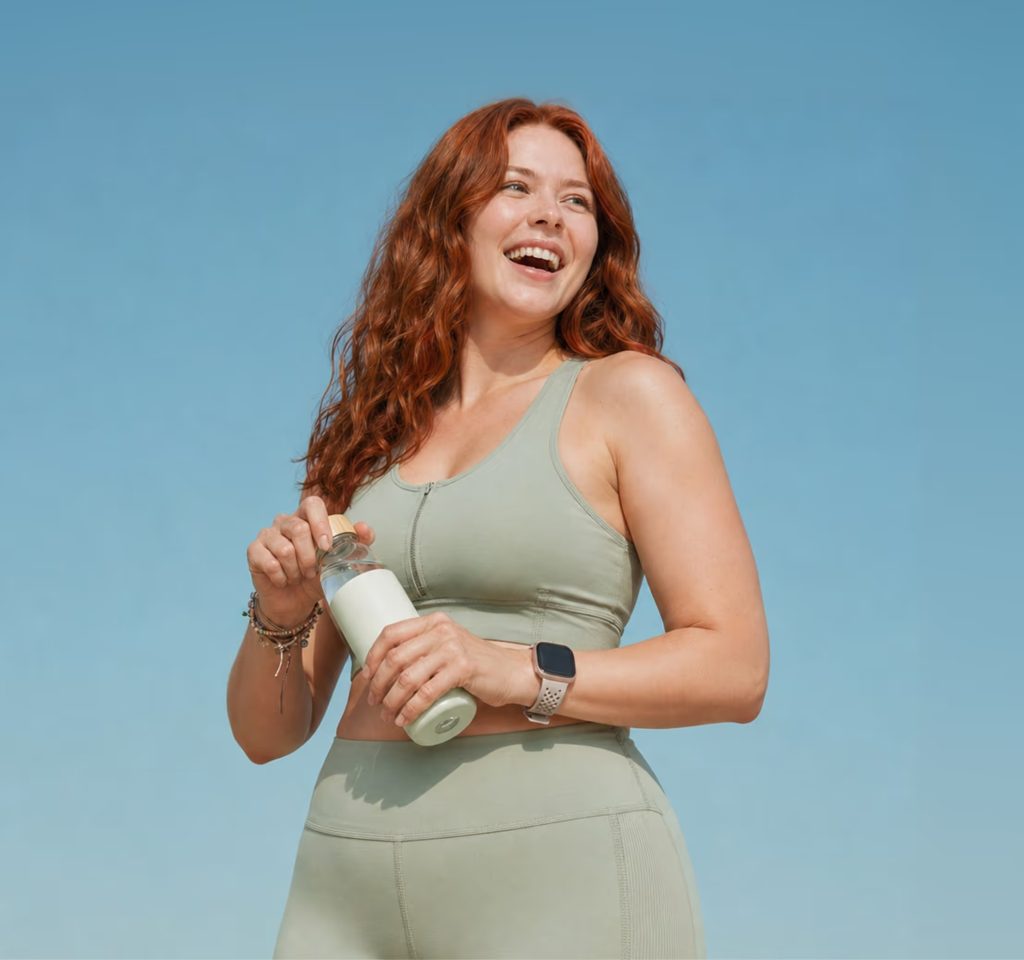 Smiling woman holding a Bolt Pharmacy treatment pot outdoors