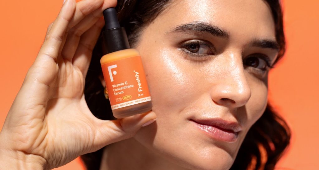 Model holding Freshly Cosmetics Vitamin C serum