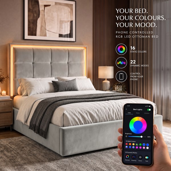 Grey velvet ottoman bed with a glowing LED headboard and a phone showing colour controls