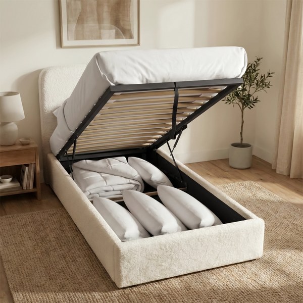 White boucle single ottoman bed with the base raised to show clothes stored inside