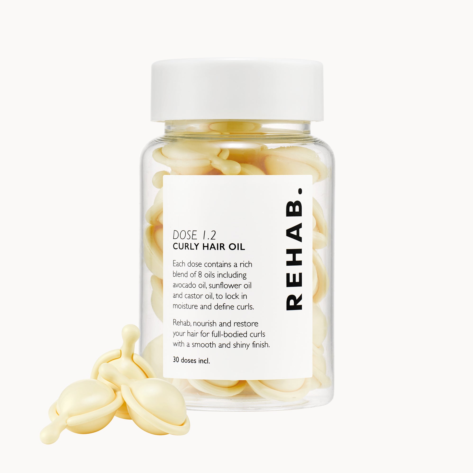 REHAB. Dose 1.2 Anti-Frizz Curly Hair Oil jar with biodegradable oil capsules