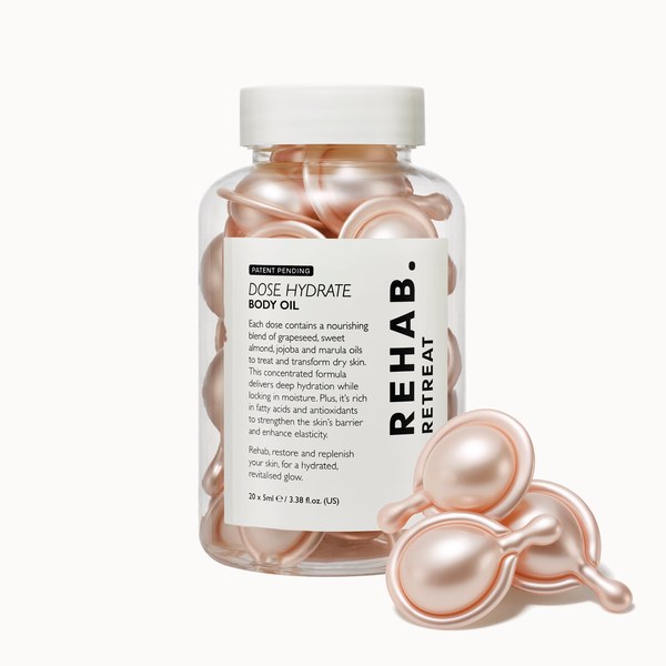 Jar of REHAB. Retreat Dose Hydrate Body Oil capsules with loose capsules in front