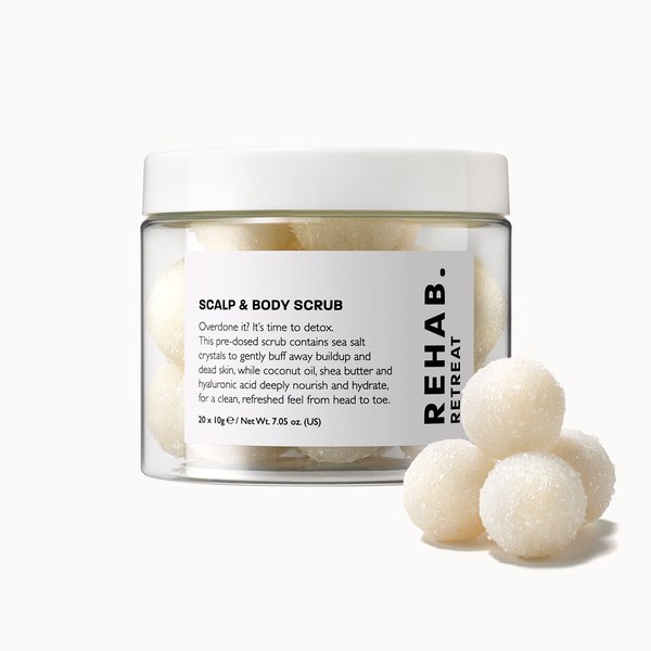 Jar of REHAB. Retreat Scalp and Body Scrub with scrub balls beside it