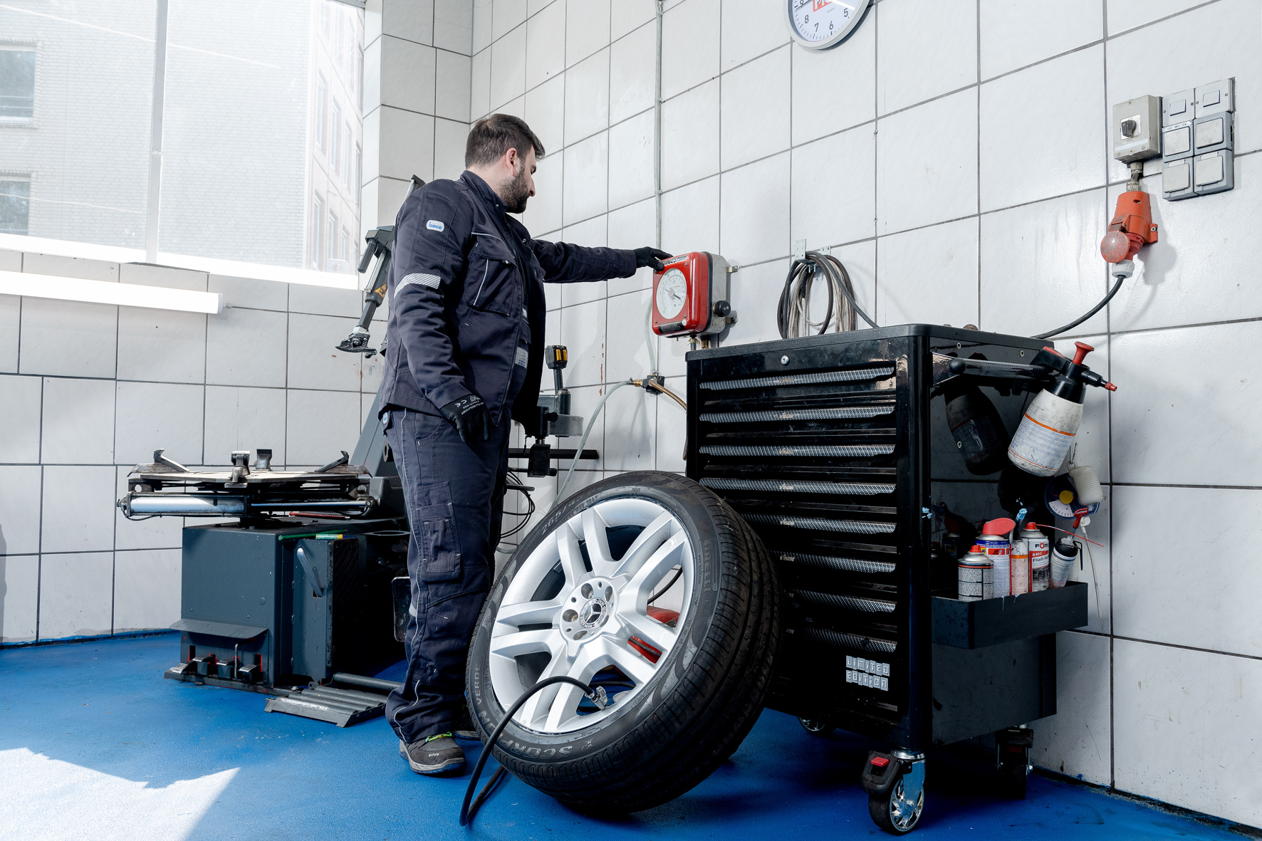 Mechanic balancing a wheel after tyre fitting