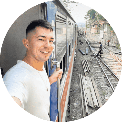 Traveler looking out of a train window - Viator